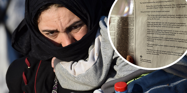 A refugee mother holds her child at a migrant collection point near Roszke village of the Hungarian-Serbian border on September 8, 2015. Around 167,000 migrants have entered Hungary illegally so far this year, with most crossing the border around the Roszke area. AFP PHOTO / ATTILA KISBENEDEK