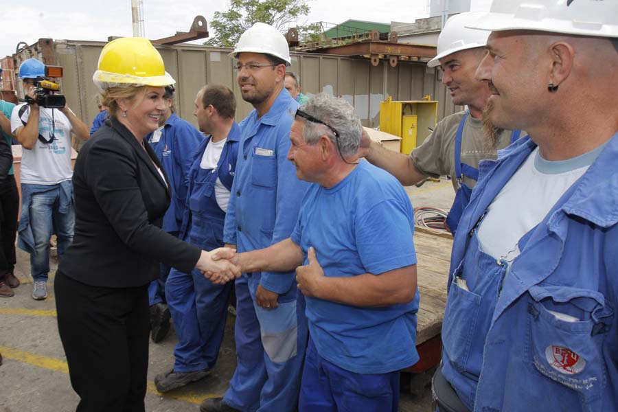 Pula, 140915.Predsjednica Republike Hrvatske Kolinda Grabar Kitarovic  jutros je u Puli otvorila privremeni Predsjednicki ured, te tim povodom posjetila brodogradiliste Uljanik. Na fotografiji: Kolinda Grabar Kitarovic s radnicima.Foto: Goran Sebelic / CROPIX
