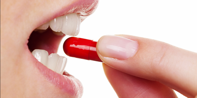 A woman takes one tablet of the capsule. Medical care drugs