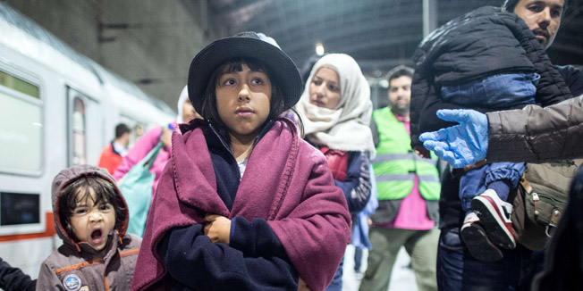 Migrants walk over a platform at the Cologne-Bonn's airport railway station after arriving with a train coming from Salzburg, Austria, on September 22, 2015. EU interior ministers will hold an emergency meeting in hopes of bridging a deep rift over Europe's worst migrant crisis since World War II, a day after Hungary gave its army drastic new powers to protect its borders.    AFP PHOTO / DPA / FEDERICO GAMBARINI   +++   GERMANY OUT