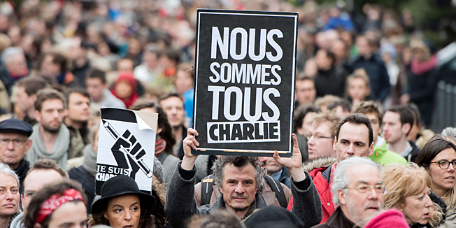 A man holds a sign reading 
