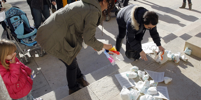 Pula, 190115.Nezadovoljne poskupljenjem cijene vrtica, ukidanjem popusta za drugo dijete u vrticu, smanjenjem sufinanciranja za djecu korisnike djecjeg doplatka te ukidanjem besplatnog bonamenta osnovnokolcima, dvadesetak mama danas se spontano okupilo na Forumu . Ispred gradske palace u znak prosvjeda ostavile su  prljave pelene.Foto: Goran Sebelic / CROPIX