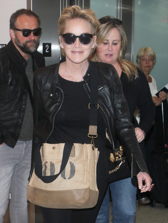 Sharon Stone arriving at LAX with friends and signs autographs January 18, 2015 X17online.com