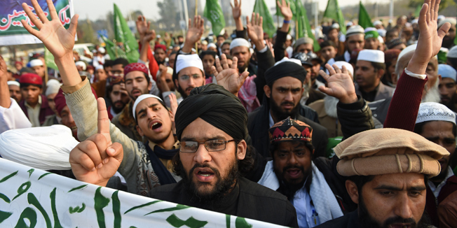 Pakistani protesters march against the printing of satirical sketches of the Prophet Muhammad by French magazine Charlie Hebdo, in Islamabad on January 18, 2015. Anti-Charlie Hebdo protests continued across Pakistan as thousands of people came on streets in almost all major cities chanting slogans against the printing of cartoons of the Prophet Mohammed in the French magazine.  AFP PHOTO/Farooq NAEEM
