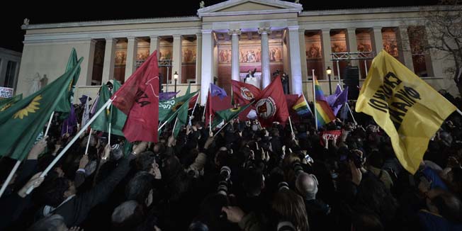 TOPSHOTSSyriza leader Alexis Tsipras greets supporters following victory in the election in Athens on January 25, 2015.  Greece is 