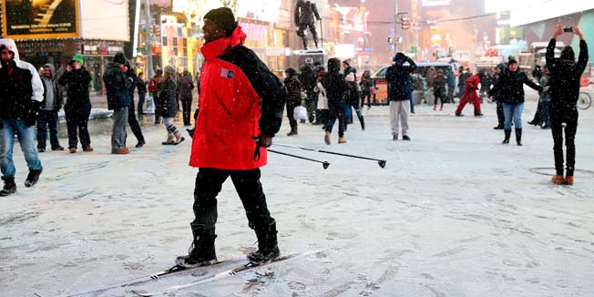 NEW YORK, NY - JANUARY 26: A man stands on skis in Times Square on January 26, 2015 in New York City. New York, and much of the Northeast, is bracing for a major winter storm which is expected to bring blizzard conditions and 10 to 30 inches of snow to the area.   Alex Trautwig/Getty Images/AFP== FOR NEWSPAPERS, INTERNET, TELCOS & TELEVISION USE ONLY ==