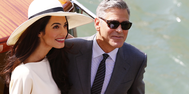 US actor George Clooney and British lawyer Amal Alamuddin leave the palazzo Ca Farsetti on a taxi boat on September 29, 2014 in Venice, after a civil ceremony to officialise their wedding. AFP PHOTO / PIERRE TEYSSOT