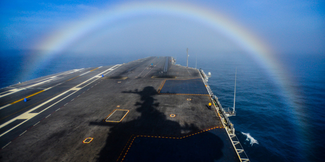 This US Navy photo obtained February 4, 2015 shows a rainbow as it forms over the bow of the Nimitz-class aircraft carrier USS John C. Stennis (CVN 74) on February 3, 2015. John C. Stennis is undergoing an operational training period in preparation for future deployments. AFP PHOTO/US NAVY/IGNACIO D. PEREZ  =  RESTRICTED TO EDITORIAL USE / MANDATORY CREDIT: 
