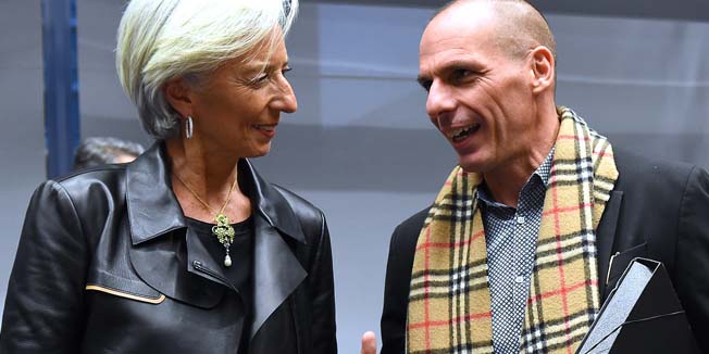 Greek Finance Minister Yanis Varoufakis (R) speaks with International Monetary Fund (IMF) Director Christine Lagarde during an emergency Eurogroup finance ministers meeting at the European Council in Brussels on February 11, 2015. Proposals by the new government in Athens to renegotiate the terms of its massive international bailout are scheduled to be discussed by eurozone finance ministers in Brussels on February 11 and 12. AFP PHOTO / EMMANUEL DUNAND