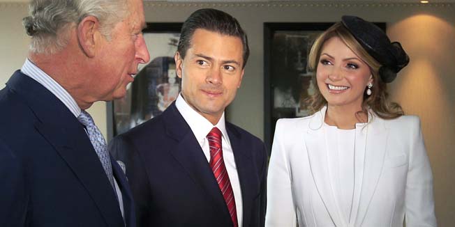 Mexican President Enrique Pena Nieto (2nd L) and his wife Angelica Rivera (2nd R) receive Britain's Prince Charles (L), Prince of Wales and Britain's Camilla (R), Duchess of Cornwall in the President's suite at the Intercontinental Hotel, Park Lane, London on March 3, 2015, at the start of the President's three-day state visit to Britain. AFP PHOTO / POOL / JONATHAN BRADY
