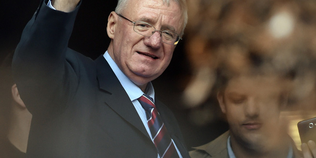 Serb  ultranationalist leader Vojislav Seselj waves at supporters on November 12, 2014 after arriving at his Radical Serb Party (SRS) headquarters in Zemun, near Belgrade . Ailing Serb leader Seselj, who has been released from the UN Yugoslav war crimes tribunal, arrived on November 12 from the Netherlands to Serbia. The International Criminal Tribunal for the former Yugoslavia (ICTY) last week ordered Seselj's release so he could return home for cancer treatment as he awaits a verdict on alleged war crimes during the Balkan wars. Seselj, accused of leading ethnic Serb volunteers in persecuting Croats, Muslims and other non-Serbs during the 1990s wars, underwent colon cancer surgery in December.  AFP PHOTO / ANDREJ ISAKOVIC