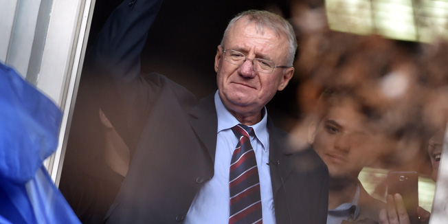 Serb  ultranationalist leader Vojislav Seselj waves at supporters on November 12, 2014 after arriving at his Radical Serb Party (SRS) headquarters in Zemun, near Belgrade . Ailing Serb leader Seselj, who has been released from the UN Yugoslav war crimes tribunal, arrived on November 12 from the Netherlands to Serbia. The International Criminal Tribunal for the former Yugoslavia (ICTY) last week ordered Seselj's release so he could return home for cancer treatment as he awaits a verdict on alleged war crimes during the Balkan wars. Seselj, accused of leading ethnic Serb volunteers in persecuting Croats, Muslims and other non-Serbs during the 1990s wars, underwent colon cancer surgery in December.  AFP PHOTO / ANDREJ ISAKOVIC