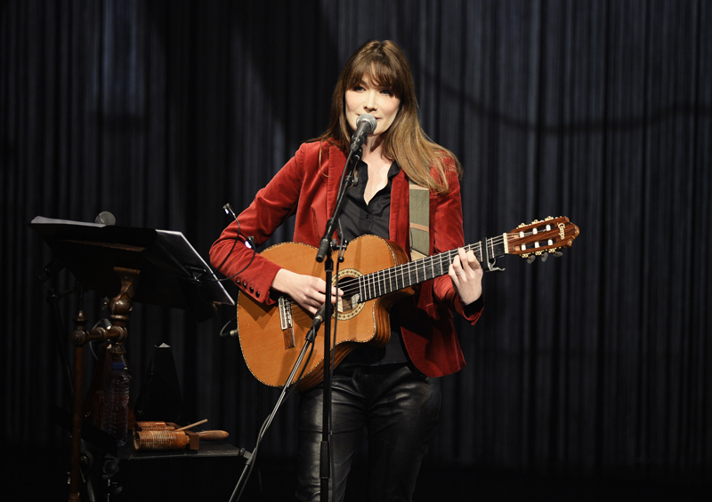 PARIS, FRANCE - MARCH 11:  (EDITORS NOTE: This image has been digitally manipulated). Carla Bruni performs on stage at L'Olympia on March 11, 2014 in Paris, France.  (Photo by Pascal Le Segretain/Getty Images)
