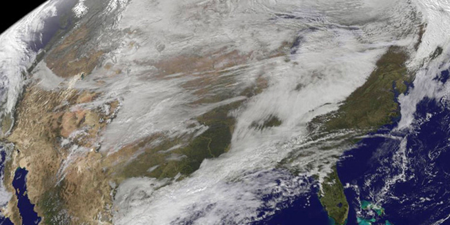 This NASA image obtained November 13, 2014 shows what the NOAA's GOES satellite captured of the the storm system that brought wintry weather in the entire US centered near Ontario, Canada. Snow is visible in the US and Canadian Rockies. NOAA's National Weather Service noted on November 12, 2014 that the storm system moving across eastern Canada will bring lake effect snow across parts of the Great Lakes through November 13, 2014. Behind the cold front, an Arctic air mass will bring much lower temperatures -- in some cases 25 to 40 degrees below normal -- across much of the northern and central US. AFP PHOTO/NASA/NOAA GOES Project/HANDOUT    =  RESTRICTED TO EDITORIAL USE / MANDATORY CREDIT: 