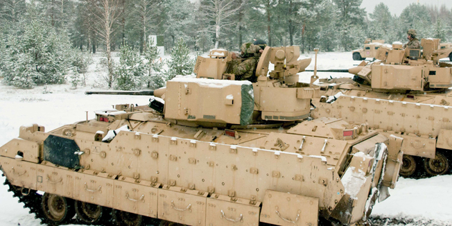 This November 21, 2014 US Army handout photo shows M2A3 Bradley Fighting Vehicles from Company A, 2nd Battalion, 8th Cavalry Regiment, 1st Brigade Combat Team, 1st Cavalry Division, preparing to start a live-fire training exercise at Adazi Training Area, Latvia as part of the US Army Europe-led Operation Atlantic Resolve land force assurance training exercise. The US Army plans to deploy about 150 tanks and armored vehicles to NATO countries next year and some of the heavy armor may be stationed in Eastern Europe, a top American general said November 25, 2014. The move is part of a US effort dubbed 