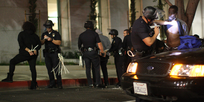 LOS ANGELES, CA - NOVEMBER 26: Protesters are arrested at one intersection during a demonstration following the grand jury decision not to indict a white police officer who had shot dead an unarmed black teenager in Ferguson, Missouri in the early morning hours of November 26, 2014 in Los Angeles, California. Police officer Darren Wilson shot 18-year-old Michael Brown on August 9, sparking large ongoing protests.   David McNew/Getty Images/AFP== FOR NEWSPAPERS, INTERNET, TELCOS & TELEVISION USE ONLY ==