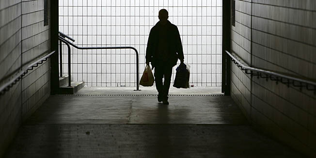 PRESTON, UNITED KINGDOM - JANUARY 23:  A man makes his way home at Preston bus station on January 23, 2005, Preston, England. Scientists from Cardiff University have worked out a formula to calculate that January 23 is the most depressing day of the year. The formula 1/8W+(D-d) 3/8xTQ MxNA where W is weather, D is debt, money (d) due on January's pay day and T is the time since Christmas, Q is the period since the failure to quit a bad habit, M for motivational levels and NA is the need to take action and do something about it.  (Photo by Christopher Furlong/Getty Images)