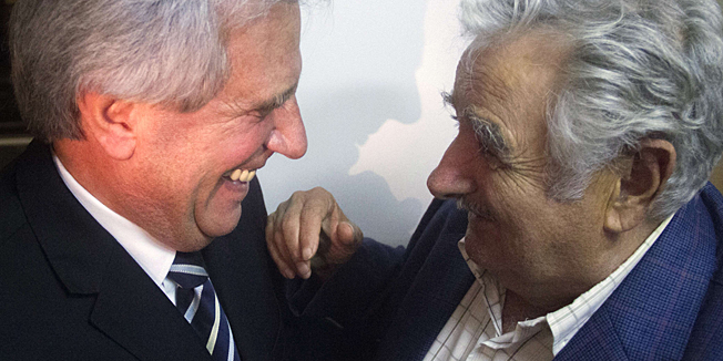 Handout photo released by the Frente Amplio press office of Uruguayan President Jose Mujica (R) as he celebrates with Uruguayan presidential candidate for the leftist coalition Frente Amplio (Broad Front) party, Tabare Vazquez, after the presidential runoff election in Montevideo on November 30, 2014. Ex-president (2005-2010) Tabare Vazquez won Uruguay's presidential runoff Sunday, extending the left's decade-long hold on power -- though not necessarily his predecessor's ground-breaking marijuana laws, exit polls showed. AFP PHOTO / Frente Amplio press office - Nico Correa 