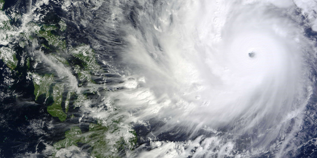 This handout photo released and taken by NASA on December 5, 2014 shows a satellite image of Typhoon Hagupit in the Western Pacific Ocean. Thousands of people in the Philippines sought shelter in churches, schools and other makeshift evacuation centres on December 5 as monster Typhoon Hagupit bore down on the disaster-weary nation. AFP PHOTO / NASA == RESTRICTED TO EDITORIAL USE / MANDATORY CREDIT: 