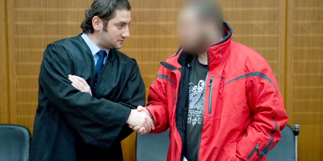 Kreshnik Berisha, 20, a jihadist militant, welcomes his lawyer Mutlu Guenal off the dock in a high-security facilities of the Higher Regional Court in Frankfurt am Main (Hessen). A German court Friday jailed a jihadist militant for three years and nine months in the country's first trial of a member of the Islamic State group fighting in Syria and Iraq.  AFP PHOTO / DPA/ BORIS ROESSLER /GERMANY OUT