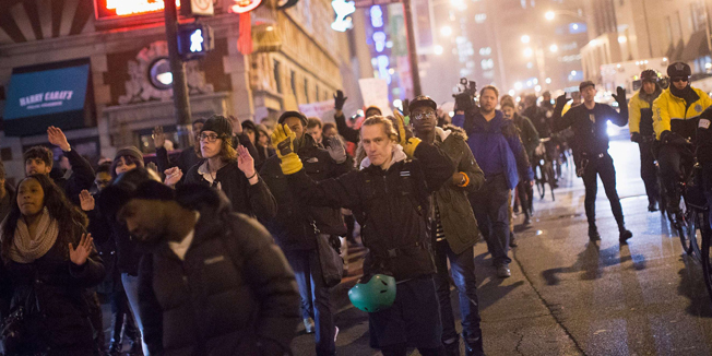 CHICAGO, IL - DECEMBER 05: Demonstrators march through the Loop protesting police abuse on December 5, 2014 in Chicago, Illinois. The protest was one of many staged nationwide after grand juries investigating the deaths of Michal Brown in Ferguson, Missouri and Eric Garner in New York failed to indict the police officers involved in both incidents.   Scott Olson/Getty Images/AFP== FOR NEWSPAPERS, INTERNET, TELCOS & TELEVISION USE ONLY ==