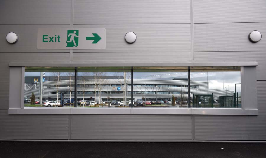 The performance centre is seen from inside the Academy Stadium at the newly opened City Football Academy in Manchester, Northern England, on December 8, 2014. AFP PHOTO / OLI SCARFFRESTRICTED TO EDITORIAL USE. No use with unauthorized audio, video, data, fixture lists, club/league logos or live services. Online in-match use limited to 45 images, no video emulation. No use in betting, games or single club/league/player publications.