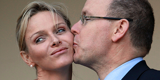 (FILES) A file photo taken on July 6, 2011 shows Prince Albert of Monaco kissing Princess Charlene, during a meeting with South African President at the King's house in Durban. Monaco's Princess Charlene arrived at a maternal ward in the principality on December 10, 2014, where she is expected to give birth to twins, witnesses said. Father-to-be Prince Albert II, who last month said the babies were due around mid-December, was also seen arriving at the hospital.AFP PHOTO / RAJESH JANTILAL