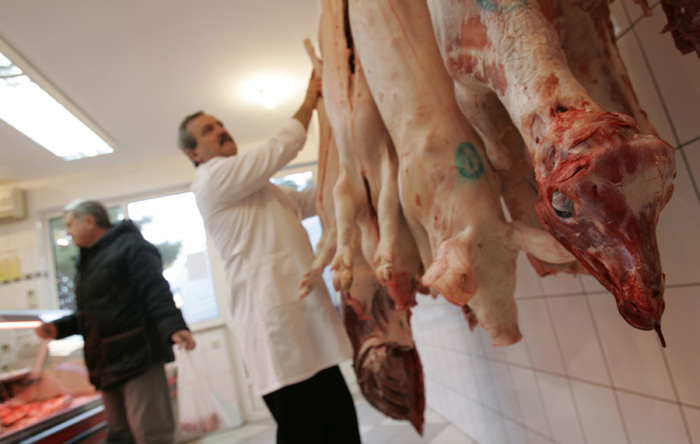 Split, 211209.Mesnice se dodatno popunjavaju uoci bozicno- novogodisnjih blagdana. Kilogram domaceg odojka kosta 35, dok je domaca janjetina 75 kuna za kilogram.Na fotografiji: mesar Luka Marasovic priprema meso za prodaju.Foto: Jakov Prkic / CROPIX