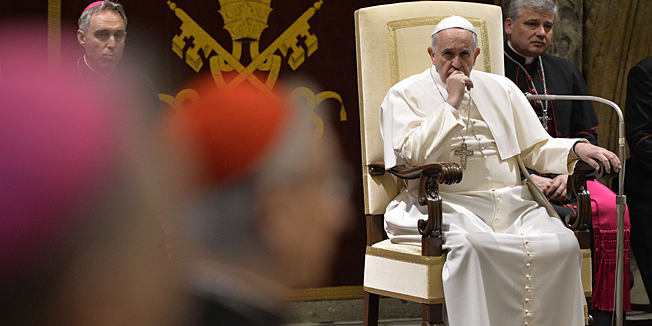 Pope Francis attends an audience of the Curia, the administrative apparatus of the Holy See, for Christmas greetings in the Sala Clementina of the Apostolic Palace at the Vatican, on December 22, 2014.  AFP PHOTO / ANDREAS SOLARO