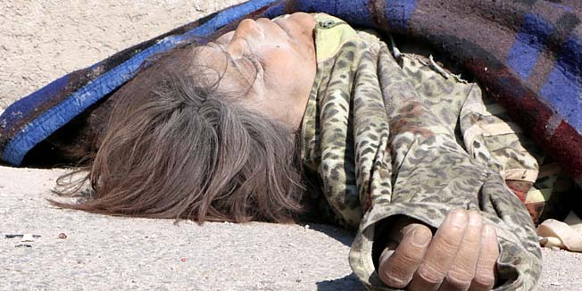GRAPHIC CONTENTA body is seen on the ground following a reported air strike by Syrian government forces on February 17, 2014 in the Hanano district of the northern Syrian city of Aleppo. The death toll in nearly three years of conflict in Syria has risen to more than 140,000 people including nearly 50,000 civilians, the Syrian Observatory for Human Rights said last week. AFP PHOTO / ALEPPO MEDIA CENTRE / FADI AL-HALABI
