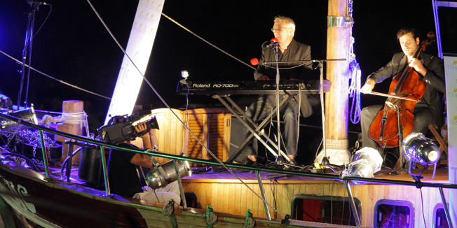 Rakalj, Pula, 300614.Prvi koncert ovogodisnjeg Kulturnog ljeta u Raklju zbio se sinoc u uvali Kalavojna. Vec tradicionalno svirali su Oliver Dragojevic i Stjepan Hauser. Glazbenici su svirali na brodu dok je publika sjedila na balama sijena na obali.Foto: Goran Sebelic / CROPIX                              