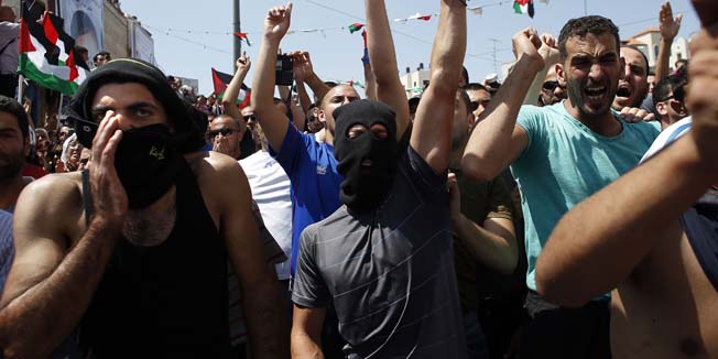 TOPSHOTSThousands of mourners shout slogans as they gather for the funeral of  Mohammed Abu Khder, 16, in Shuafat, in Israeli annexed East Jerusalem, on July 4, 2014. Abu Khder, a Palestinian teenager was reportedly kidnapped and killed, triggering violent clashes in east Jerusalem, in an apparent act of revenge for the murder by militants of three Israeli youths.  AFP PHOTO / THOMAS COEX