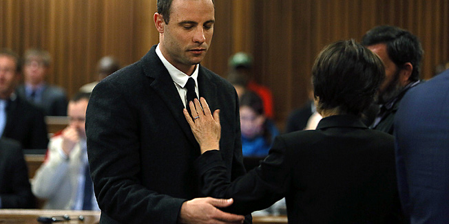 An unidentified woman places her hand on the chest of South African Paralympic athlete Oscar Pistorius after adjusting his tie during his ongoing murder trial in Pretoria, South Africa, on July 8, 2014. Pistorius stands trial for the murder of his girlfriend Reeva Steenkamp in February 2013. Lawyers defending Oscar Pistorius on charges of murdering his girlfriend Reeva Steenkamp rested their case on July 8, allowing the court to set a date of August 7-8 for final arguments. AFP PHOTO / POOL / ALON SKUY