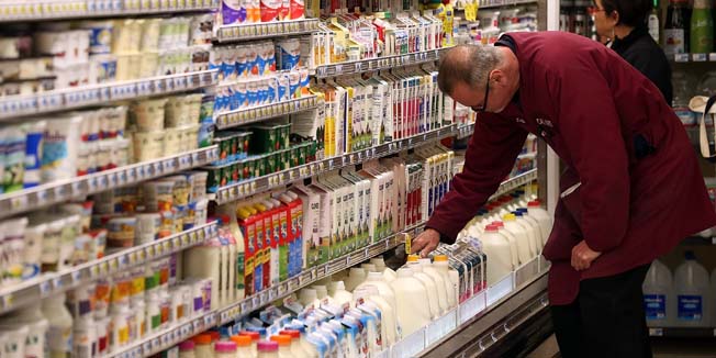 SAN FRANCISCO, CA - MARCH 27: A clerk adjusts containers of milk at Cal-Mart Grocery on March 27, 2014 in San Francisco, California. Food prices are on the rise and expected to keep edging up throughout the year as the drought and other factors have impacted the availability and cost of groceries like coffee, milk, limes and pork.   Justin Sullivan/Getty Images/AFP== FOR NEWSPAPERS, INTERNET, TELCOS & TELEVISION USE ONLY ==