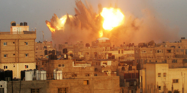 A ball of fire is seen following an early morning Israeli air strike, on July 11, 2014, on Rafah in the southern of Gaza strip. Israeli warplanes kept up deadly raids on Gaza but failed to stop Palestinian militants firing rockets across the border, as the United States offered to help negotiate a truce. AFP PHOTO / SAID KHATIB