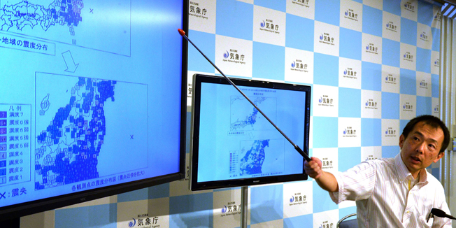 Japan Meteorological Agency officer Yasuhiro Yoshida speaks during a press conference in Tokyo on July 12, 2014, after a strong 6.8 magnitude earthquake struck off the country's Pacific coast. A minor tsunami hit large swathes of northeastern Japan early on July 12, including in a city near the crippled Fukushima nuclear plant. AFP PHOTO / Yoshikazu TSUNO