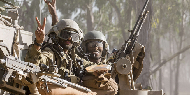 Israeli soldiers flash the 