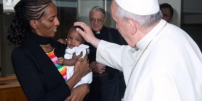 A handout photo released by the Osservatore Romano and taken on July 24, 2014 shows Pope Francis greeting Sudanese Christian Meriam Yahia Ibrahim Ishag and her daughter Maya during a private audience at the Vatican. Ishag who was sentenced to death for renouncing Islam, then acquitted after intense international pressure on Khartoum, arrived today in Italy with her family en route to the United States. AFP PHOTO/ OSSERVATORE ROMANO   -RESTRICTED TO EDITORIAL USE - MANDATORY CREDIT 