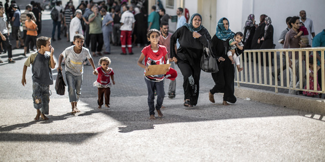 A Palestinian family, who fled the UN school that was hit by an Israeli tank shell, arrive at the Beit Hanun hospital on July 24, 2014. Fifteen people were killed when Israeli fire hit a UN-run school in Gaza, raising the Palestinian toll on the 17th day of the conflict to 777, medics said. AFP PHOTO/MARCO LONGARI