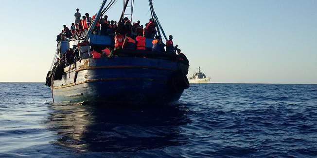 This handout picture released by the Italian Navy on July 23, 2014 shows migrants on a boat on the Mediterranean Sea, after being rescued by the Italian Navy. The Italian Navy rescued 620 migrants. AFP PHOTO / HAND OUT / MARINA MILITARE --RESTRICTED TO EDITORIAL USE - MANDATORY CREDIT 