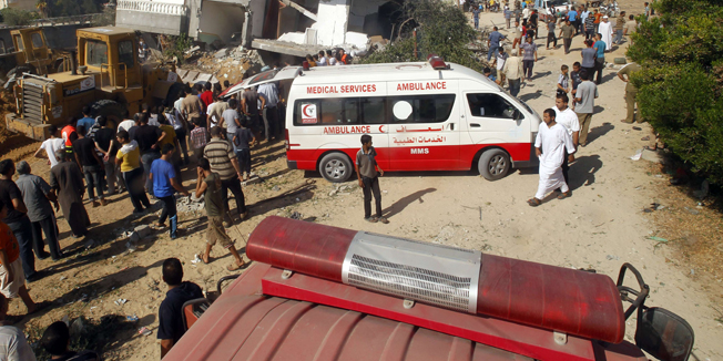 Palestinian rescue workers search the rubble for survivors following an Israeli military strike on Rafah, in the southern Gaza Strip, on August 1, 2014. A 72-hour ceasefire took effect today in Gaza but was immediately threatened by deadly shelling, as diplomats pressed for a more durable end to 25 days of devastating violence. AFP PHOTO/ SAID KHATIB