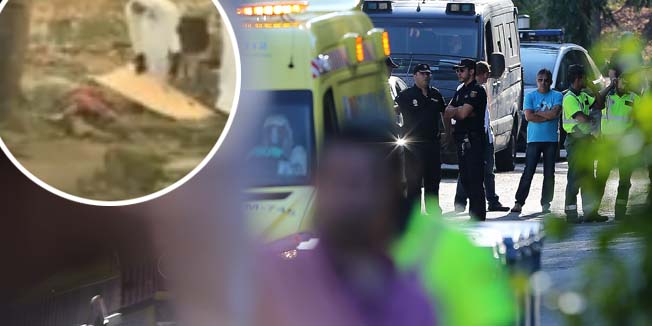 Police officers stand guard as an ambulance carrying Roman Catholic priest Miguel Pajares, who contracted the deadly Ebola virus, arrives at the Carlos III hospital in Madrid on August 7, 2014. An elderly Spanish missionary infected with the deadly Ebola virus in Liberia landed in Madrid today, the first patient in the fast-spreading outbreak to be evacuated to Europe for treatment.  AFP PHOTO / CESAR MANSO