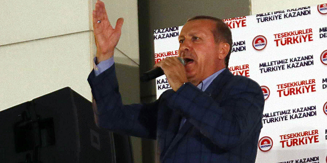 Newly elected Turkish president Recep Tayyip Erdogan addresses supporters from the balcony of the AKP party headquarters during the celebrations of his victory in the presidential election vote in Ankara on August 10, 2014. Prime Minister Recep Tayyip Erdogan on Sunday won Turkey's presidency in the first round of elections with 52.1 percent of the vote, an almost complete vote count said.  Erdogan's main rival Ekmeleddin Ihsanoglu won 38.8 percent of the vote and Kurdish candidate Selahattin Demirtas 9.1 percent of the vote, Turkish television channels said, based on a 99 percent vote count.AFP PHOTO/ADEM ALTAN