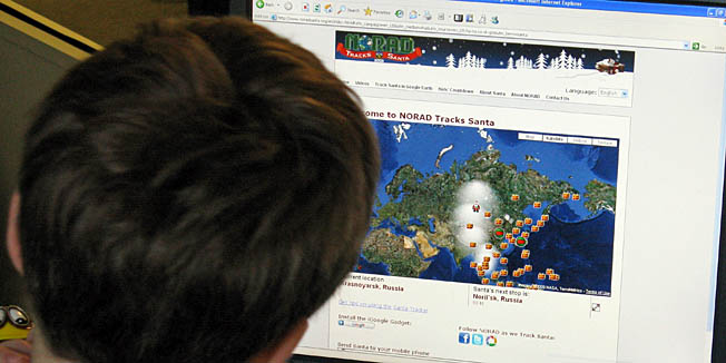 In this illustration, a young boy looks at the website (www.noradsanta.org) to check on the progress of Santa Claus on December 24, 2009 in Washington, DC. The North American Aerospace Defense Command, which monitors the North American airspace, on Thursday set up an official 