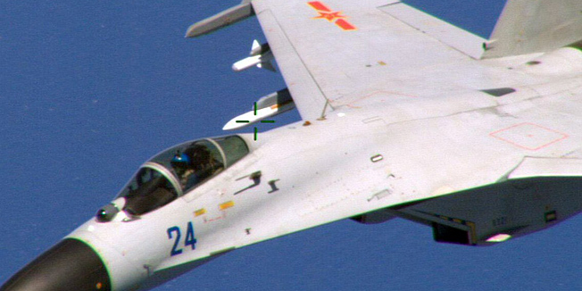 This image obtained August 22, 2014, courtesy of the Department of Defense shows a Chinese fighter jet in a photo taken by a US Navy P-8 crew. A Chinese fighter jet flew perilously close to a US military aircraft in international airspace this week in a 