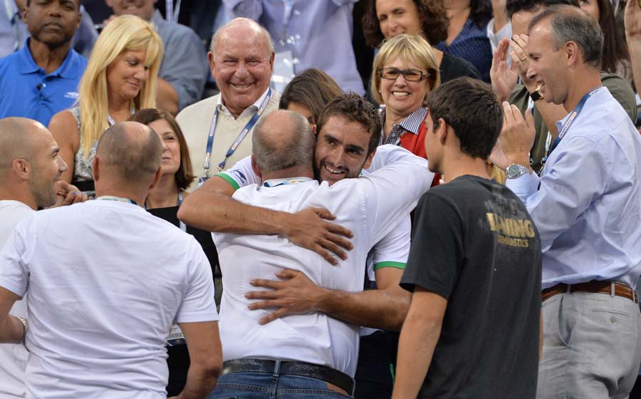 Marin Cilic of Croatia celebrates his victory with his team over Kei Nishikori of Japan during their US Open 2014 men's singles finals match at the USTA Billie Jean King National Center September 8, 2014  in New York. AFP PHOTO/Stan Honda