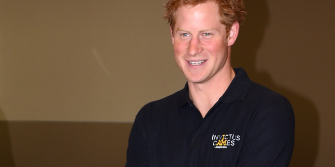 Britain's Prince Harry (R) speaks with team GB's Dave Henson as he meets with team captains taking part in the upcoming Invictus Games, in London, on September 8, 2014. Invictus Games is a multi-sport event for injured armed services personnel from 14 nations taking place in London from 10-14 September. AFP PHOTO/POOL/JEREMY SELWYN