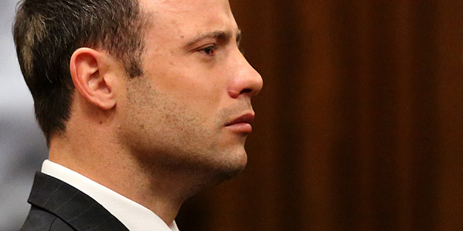 Olympic and Paralympic track star Oscar Pistorius listens to the verdict in his trial at the high court in Pretoria on  September 12 2014.A South African judge on Friday found Olympic and paralympic track star Oscar Pistorius guilty of culpable homicide for the Valentine's Day shooting last year of his model girlfriend Reeva Steenkamp.As Pistorius stood impassively in the dock with his hands folded in front of him, Judge Thokozile Masipa read out her verdict, which could carry a sentence of up to 15 years in prison. AFP PHOTO/Siphiwe Sibeko/POOL 