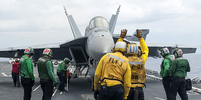 This US Navy handout photo taken September 1, 2014 shows an F/A-18E Super Hornet from the Sunliners of Strike Fighter Squadron (VFA) 81 as it taxis onto a catapult prior to launching from the flight deck of the aircraft carrier USS Carl Vinson (CVN 70) in the Pacific Ocean. Two US F/A-18 Hornet jets have crashed in the western Pacific and one of the pilots is missing, the Navy said September 12, 2014. The incident, which is under investigation, occurred at 5:40 p.m. local time, according to a statement from the US 7th Fleet. The Hornets -- both of which have not been recovered -- were from Carrier Air Wing 17 embarked on the aircraft carrier USS Carl Vinson. While one pilot was rescued and is currently receiving medical care, a search is underway for the second airman. AFP PHOTO/US NAVY/John Philip Wagner, Jr./HANDOUT  = RESTRICTED TO EDITORIAL USE - MANDATORY CREDIT 