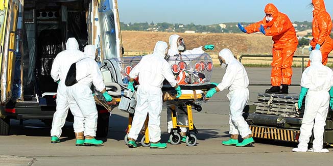 A handout picture taken and released on August 7, 2014 by the Spanish Defense Ministry shows aid workers and doctors transferring Roman Catholic priest Miguel Pajares, who contracted the deadly Ebola virus, and Spanish nun Juliana Bonoha Bohe from Madrid's Torrejon air base to the Carlos III hospital upon their arrival in Spain. An elderly Spanish missionary infected with the deadly Ebola virus in Liberia landed in Madrid today, the first patient in the fast-spreading outbreak to be evacuated to Europe for treatment. AFP PHOTO / SPANISH DEFENSE MINISTRY / INAKI GOMEZRESTRICTED TO EDITORIAL USE - MANDATORY CREDIT 